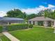 Exterior view showcasing the lush greenery and landscaping surrounding the property, including a screened pool area at 19123 Sheldon St, Orlando, FL 32833