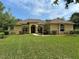 Beautiful single-story home with a well-manicured lawn and a charming front entrance with beautiful landscaping at 19123 Sheldon St, Orlando, FL 32833