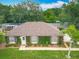 Charming home featuring an ivy-covered facade, well-kept lawn, and a neatly landscaped front yard with a palm tree at 19123 Sheldon St, Orlando, FL 32833