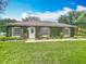 Charming home featuring well-manicured lawn and lovely green facade at 19123 Sheldon St, Orlando, FL 32833