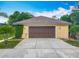Detached two-car garage with brown door and ample driveway space at 19123 Sheldon St, Orlando, FL 32833
