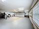 Spacious garage with ample room for vehicles and storage, featuring multiple workbenches and natural light at 19123 Sheldon St, Orlando, FL 32833