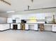 Organized garage featuring extensive cabinetry, multiple work stations, and ample lighting for various projects and hobbies at 19123 Sheldon St, Orlando, FL 32833