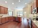 An open kitchen featuring granite countertops, rich wood cabinets, and a view of the adjacent dining area at 19123 Sheldon St, Orlando, FL 32833