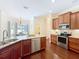 A well-equipped kitchen with stainless steel appliances, granite countertops, and dark wood cabinetry at 19123 Sheldon St, Orlando, FL 32833