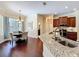 The open kitchen features granite countertops and a seamless view of the adjacent dining area at 19123 Sheldon St, Orlando, FL 32833