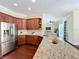 Kitchen boasting granite countertops, stainless steel appliances, and views into the living area at 19123 Sheldon St, Orlando, FL 32833