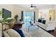 Open living room with neutral color palette and view of the pool through sliding glass doors at 19123 Sheldon St, Orlando, FL 32833