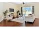Inviting living room with hardwood floors, neutral paint, and sliding glass doors to the pool and patio at 19123 Sheldon St, Orlando, FL 32833