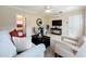 Cozy living room showcasing stylish furnishings, a modern entertainment center, and a view into the bedroom at 19123 Sheldon St, Orlando, FL 32833