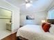 This primary bedroom boasts a view into the primary bathroom, wood floors, and double closets at 19123 Sheldon St, Orlando, FL 32833