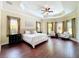 Large main bedroom featuring tray ceilings, hardwood floors and sitting area at 19123 Sheldon St, Orlando, FL 32833