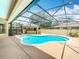 A beautiful, screened-in pool featuring an outdoor kitchen for all your entertaining needs at 19123 Sheldon St, Orlando, FL 32833