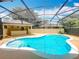 Beautiful in-ground pool surrounded by a screened enclosure and covered patio area at 19123 Sheldon St, Orlando, FL 32833