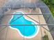 Birds eye view of a screened in pool and back yard with a built in outdoor kitchen area at 19123 Sheldon St, Orlando, FL 32833