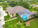 A beautiful exterior view shows the well-manicured lawn, mature trees, and screened-in pool and patio area of the home at 19123 Sheldon St, Orlando, FL 32833