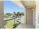 View from the balcony of a condo featuring metal railing, storage closet, and view of the community at 1932 Lake Atriums Cir # 69, Orlando, FL 32839