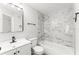 Bathroom features a sleek vanity with black fixtures and marble tiled tub at 1932 Lake Atriums Cir # 69, Orlando, FL 32839