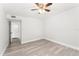 Bright bedroom with a ceiling fan, closet, and an entry door at 1932 Lake Atriums Cir # 69, Orlando, FL 32839