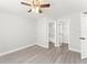 Bedroom featuring neutral walls, modern ceiling fan, and doors to the bathroom and closet at 1932 Lake Atriums Cir # 69, Orlando, FL 32839
