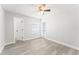 Bright bedroom features neutral walls, wood-look flooring, and a door to the outside at 1932 Lake Atriums Cir # 69, Orlando, FL 32839