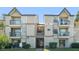 Exterior view of a two-story condo building with balconies and well-maintained landscaping at 1932 Lake Atriums Cir # 69, Orlando, FL 32839