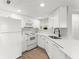 Well-lit kitchen featuring white cabinets, quartz countertops, and stainless steel appliances at 1932 Lake Atriums Cir # 69, Orlando, FL 32839