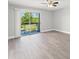 Open living room with sliding glass doors leading to balcony with green views and natural light at 1932 Lake Atriums Cir # 69, Orlando, FL 32839