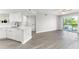Bright open floor plan with modern kitchen, island, stainless steel appliances, and sliding glass door to balcony at 1932 Lake Atriums Cir # 69, Orlando, FL 32839
