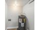 A small utility room featuring a hot water heater, painted walls, and cement flooring at 1932 Lake Atriums Cir # 69, Orlando, FL 32839