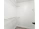 A walk-in closet contains white wire shelving along the walls and wood-look flooring at 1932 Lake Atriums Cir # 69, Orlando, FL 32839