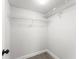 Walk-in closet contains white wire shelving along the walls and wood-look flooring at 1932 Lake Atriums Cir # 69, Orlando, FL 32839