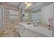 Bathroom with large vanity, an expansive mirror and a shower and tub combo at 2040 Mohawk Trl, Maitland, FL 32751