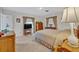 Traditional main bedroom with carpeted flooring and two windows with light-blocking curtains at 2040 Mohawk Trl, Maitland, FL 32751