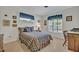 Cozy bedroom features carpeted flooring, a colorful bedspread and a window to the backyard at 2040 Mohawk Trl, Maitland, FL 32751
