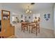 Bright dining area adjacent to the living room, featuring a chandelier and neutral decor at 2040 Mohawk Trl, Maitland, FL 32751