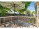 Outdoor wooden deck with a shade umbrella, perfect for relaxation and entertaining at 205 S Highland Ave, Apopka, FL 32703