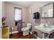 Cozy bathroom featuring elegant purple walls, toilet, sink, mirror, and convenient accessories at 205 S Highland Ave, Apopka, FL 32703