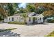 Well-maintained exterior with mature landscaping, ample parking, and side garage at 205 S Highland Ave, Apopka, FL 32703