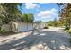 Exterior view of building featuring a two car garage and a long driveway on a sunny day at 205 S Highland Ave, Apopka, FL 32703