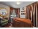 Relaxing massage room featuring a massage table, elegant dresser, mirror, and decorative curtains at 205 S Highland Ave, Apopka, FL 32703