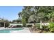 A backyard offers a patio table with chairs, lush landscaping and privacy fence at 2109 Montana St, Orlando, FL 32803