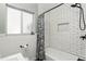 Bright bathroom features a white tiled shower and tub with a black shower head at 2109 Montana St, Orlando, FL 32803