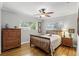 A cozy bedroom features wood floors, dresser and ceiling fan at 2109 Montana St, Orlando, FL 32803