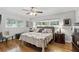 A beautifully staged main bedroom boasts a king bed and hardwood flooring at 2109 Montana St, Orlando, FL 32803