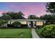 Attractive home with manicured lawn and professional landscaping at twilight at 2109 Montana St, Orlando, FL 32803
