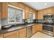 Functional kitchen with stainless steel appliances, granite countertops and wooden cabinetry at 2109 Montana St, Orlando, FL 32803