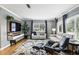 Bright living room with hardwood floors, large windows, and a modern entertainment center at 2109 Montana St, Orlando, FL 32803
