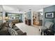 Bright living room with light blue walls, tiled floors, and large windows providing natural light at 2109 Montana St, Orlando, FL 32803