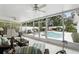 Screened patio with comfortable seating overlooks sparkling pool and landscaped backyard at 2109 Montana St, Orlando, FL 32803